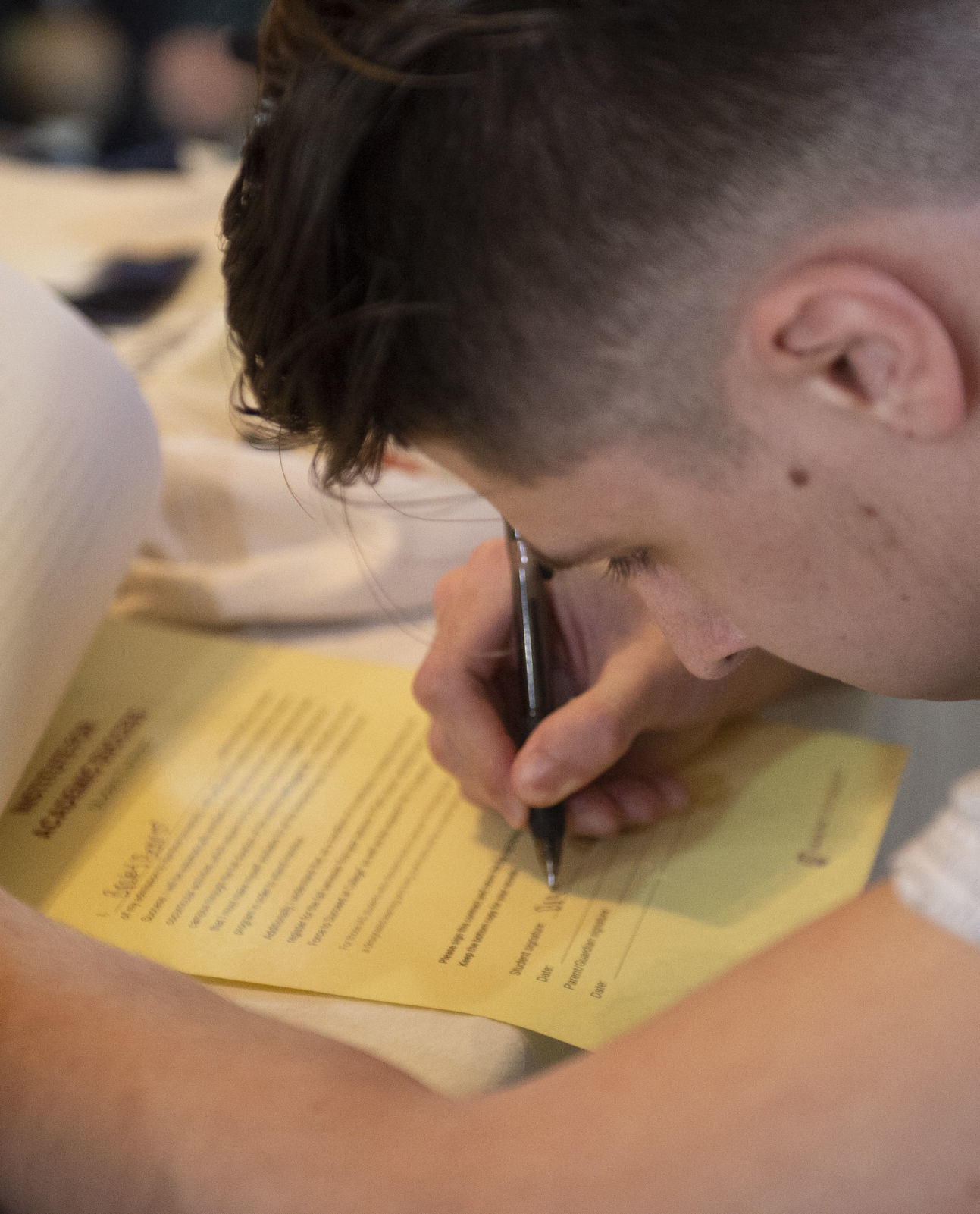 Lighthouse grad signs with Hamline University